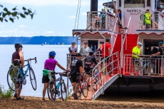 Riders load their bikes onto the Pearl of the Lake paddlewheel boat for the trip from Stockholm, Wis., back to Lake City at a previous Tour de Pepin.
-Photo by Ben Threinen